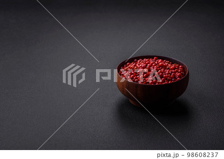 Spice, allspice peas of red or pink color in a wooden bowl Spice, allspice peas of red or pink color in a wooden bowl 98608237