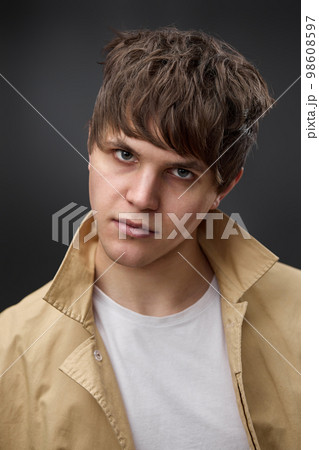 portrait of caucasian man with hairstyle in coat portrait of caucasian man with hairstyle in coat 98608597