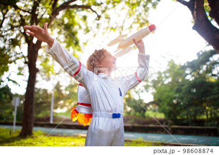 Little boy playing with spaceship. Astronaut kid. 98608874