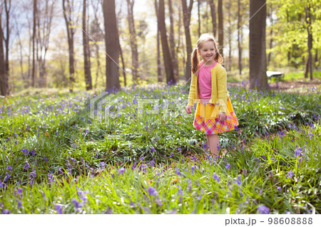 Child with bluebell flowers in spring forest Child with bluebell flowers in spring forest 98608888