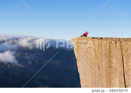 Guy on the Rock Preikestolen, Norway 98609870