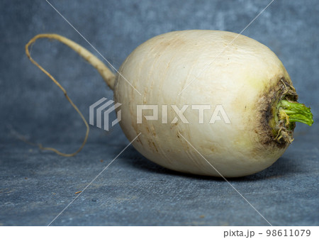 Daikon on a black background. large root, Japanese radish. Daikon on a black background. large root, Japanese radish. 98611079