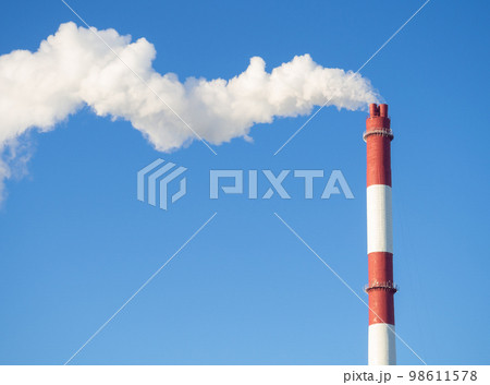 Pipes with smoke in winter. Industrial area. Unfavorable ecology. Pipes with smoke in winter. Industrial area. Unfavorable ecology. 98611578