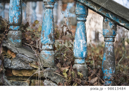 a balustrade on the railing of an old cracked staircase 98613484