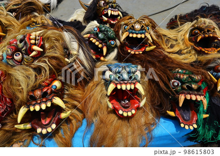 a row of wooden devil masks for Indonesian traditional dance a row of wooden devil masks for Indonesian traditional dance 98615803
