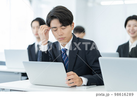 ビジネスセミナー 居眠りをする若いスーツのビジネスマン ビジネスセミナー 居眠りをする若いスーツのビジネスマン 98616289