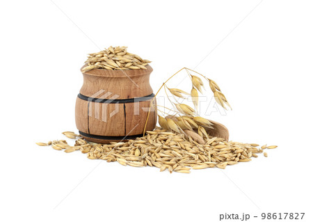 Wooden barrel filled with oats with husks on white background Wooden barrel filled with oats with husks on white background 98617827