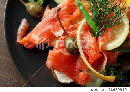 Sandwich with salmon and greens. 98620916