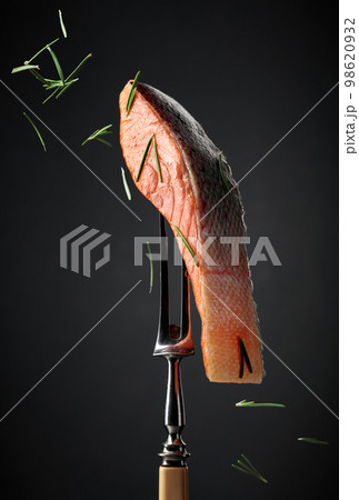 Smocked salmon sprinkled with rosemary. 98620932