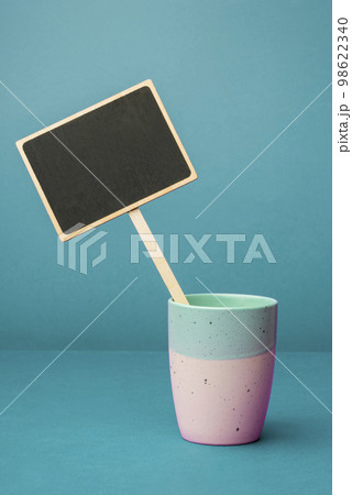 Coffee Cup Standing on Desk. Important infrormation written on paper. Different Office Supplies, Pencils, Pens, Marckers. Computer keyboard. Text on wood table. Coffee Cup Standing on Desk. Important infrormation written on paper. Different Office Supplies, Pencils, Pens, Marckers. Computer keyboard. Text on wood table. 98622340