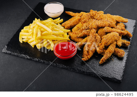 Fried chicken, nuggets and french fries 98624495