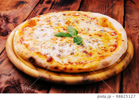 Pizza Margarita on a wooden background 98625127