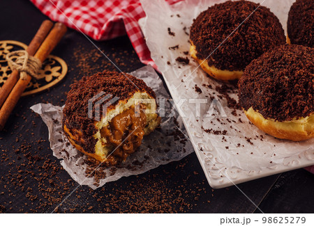 Chocolate doughnut with gooey filling inside 98625279