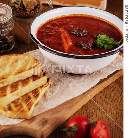 Traditional mexican red pozole soup in bowl 98625280