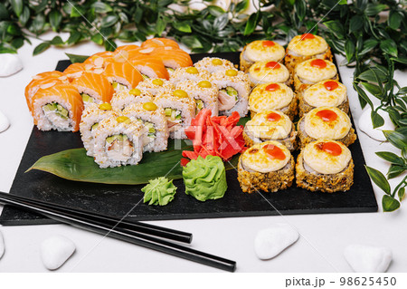 different sushi rolls on a big plate 98625450
