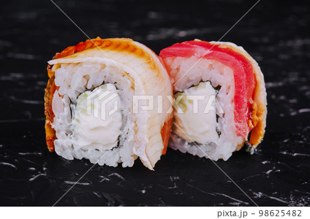 Eel and tuna sushi rolls on stone Eel and tuna sushi rolls on stone 98625482