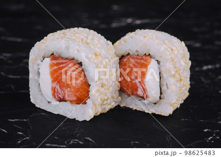 Japanese sushi rolls with salmon in rice and sesame Japanese sushi rolls with salmon in rice and sesame 98625483