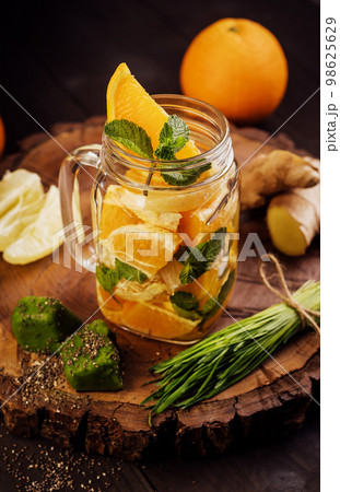 sliced fruits on a wooden board and in a glass sliced fruits on a wooden board and in a glass 98625629