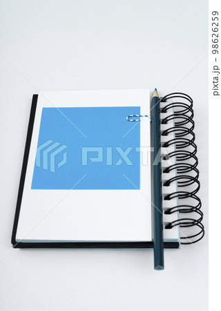 Notebook and Colored Papers Stickers Lying On White Desk. Multiple Assorted Collection Office Stationery. Photo With Pens Pencils Rullers Calculators. Notebook and Colored Papers Stickers Lying On White Desk. Multiple Assorted Collection Office Stationery. Photo With Pens Pencils Rullers Calculators. 98626259