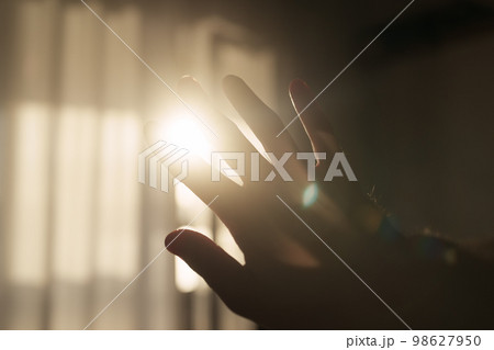 Abstract man hand playing with sunset light indoor 98627950