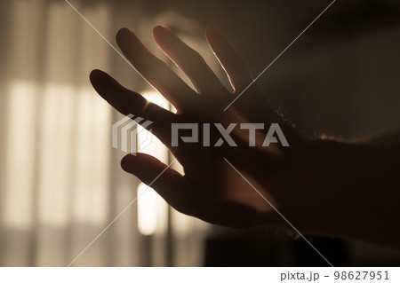 Abstract man hand playing with sunset light indoor 98627951