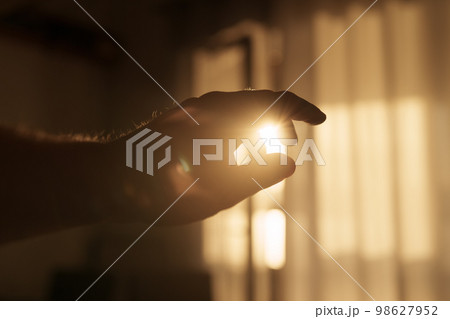 Abstract man hand playing with sunset light indoor Abstract man hand playing with sunset light indoor 98627952