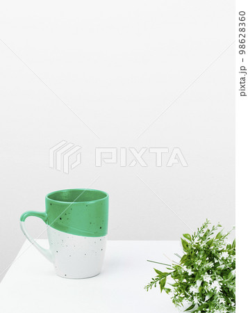 Coffee Cup Standing on Desk. Important infrormation written on paper. Different Office Supplies, Pencils, Pens, Marckers. Computer keyboard. Text on wood table. 98628360