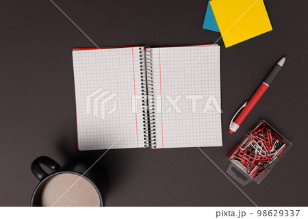 Coffee Cup Standing on Desk. Important infrormation written on paper. Different Office Supplies, Pencils, Pens, Marckers. Computer keyboard. Text on wood table. Coffee Cup Standing on Desk. Important infrormation written on paper. Different Office Supplies, Pencils, Pens, Marckers. Computer keyboard. Text on wood table. 98629337