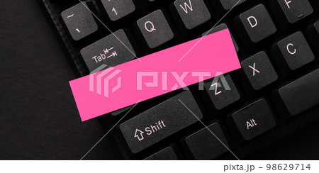 Colored sticker lying on black keyboard. Important information written over paper. Image with school supplies. Multiple Assorted Collection Office Stationery. Colored sticker lying on black keyboard. Important information written over paper. Image with school supplies. Multiple Assorted Collection Office Stationery. 98629714