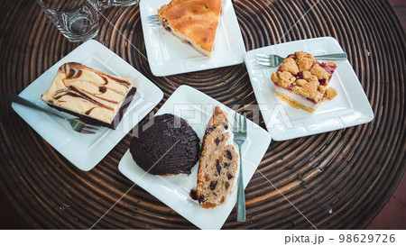 Traditional german Christmas stollen cake or Christstollen and other cakes at a cafe Traditional german Christmas stollen cake or Christstollen and other cakes at a cafe 98629726