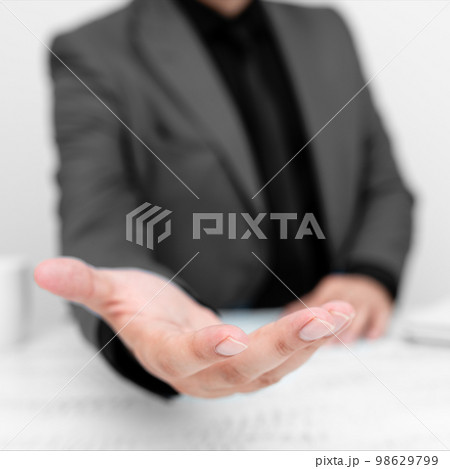 Businessman in Grey jacket Holding Important Message In One Hand. Man In Suit Showing New Crutial Idea In Palm. Executive Presenting Updated Critical Information. 98629799