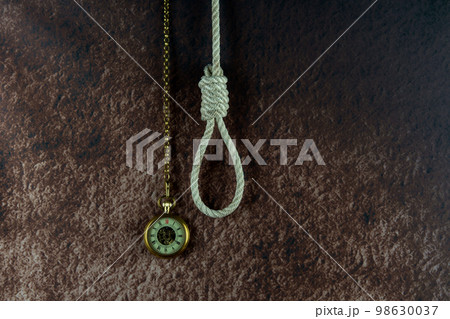 Vintage Pocket Watch and Hangmans Noose on a Mottled Background Vintage Pocket Watch and Hangmans Noose on a Mottled Background 98630037