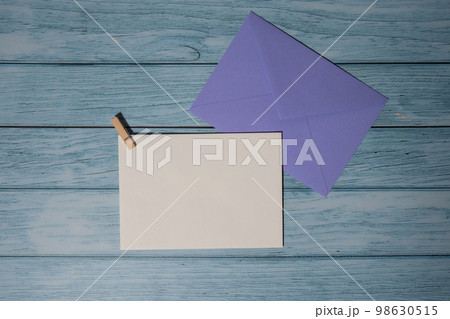 Greeting or invitation card mock up with violet envelope on wooden background. Valentines day, Happy fathers mothers day, Womens day holiday. Blank paper card copy space for your text. Holiday morning Greeting or invitation card mock up with violet envelope on wooden background. Valentines day, Happy fathers mothers day, Womens day holiday. Blank paper card copy space for your text. Holiday morning 98630515