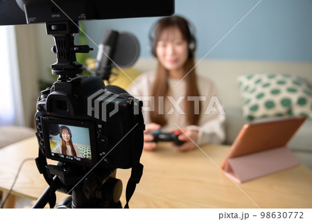 一眼レフ動画撮影、タブレットとマイクでゲーム配信する女性　ピントカメラ　ゲーム実況　ユーチューバー　 98630772