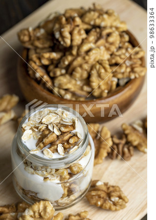 yogurt made from milk with walnuts and muesli yogurt made from milk with walnuts and muesli 98633364