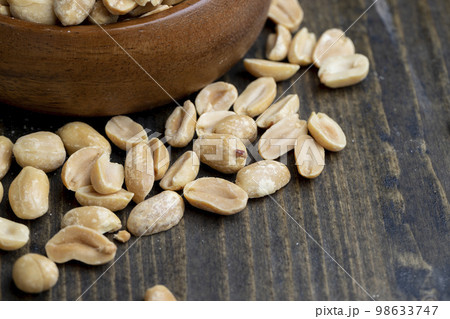 Peeled and roasted peanuts on the table 98633747