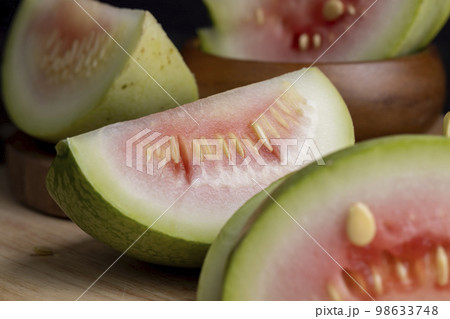 cut small unripe watermelon on a board 98633748