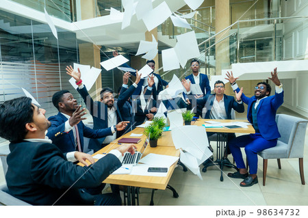 international group of nine african american and indian people having fun and throwing paper up after brain storm in big office international group of nine african american and indian people having fun and throwing paper up after brain storm in big office 98634732
