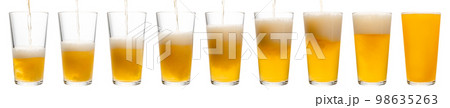 Pouring beer in shaker pint glass isolated Pouring beer in shaker pint glass isolated 98635263