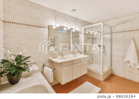 a bathroom with a sink, toilet, and bathtub in the same color as it appears on the wall 98636264