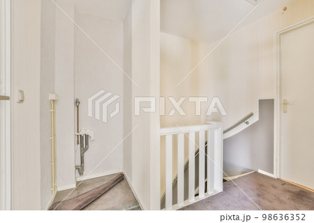 the inside of a house with white walls and stairs leading up to an open door that leads to another room the inside of a house with white walls and stairs leading up to an open door that leads to another room 98636352