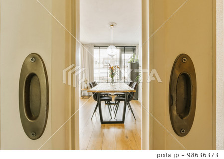 an open door leading to a dining room with two chairs and a table in the doorwayd entryway area an open door leading to a dining room with two chairs and a table in the doorwayd entryway area 98636373