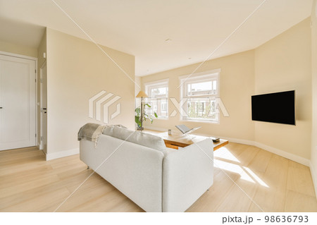 a living room with wood flooring and white couches in the room is very clean, but there is no furniture 98636793