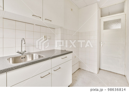 a kitchen with white cabinets and black granite counter tops on the counter top in this photo is taken to the left a kitchen with white cabinets and black granite counter tops on the counter top in this photo is taken to the left 98636814