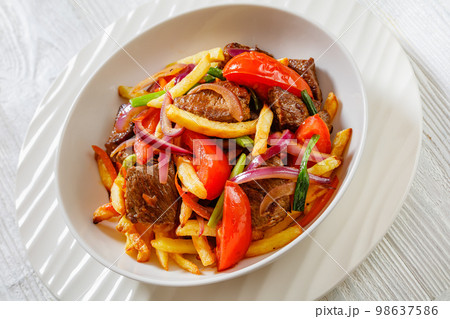 Lomo saltado, fried beef, french fries, veggies Lomo saltado, fried beef, french fries, veggies 98637586