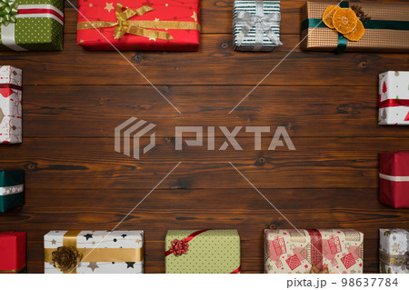 Colorful gift boxes framing a blank copy space on a desktop, top view. 98637784