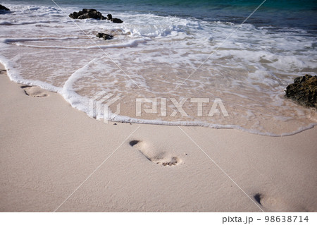 Gentle wave washed away the footprints on the sand beach. Gentle wave washed away the footprints on the sand beach. 98638714