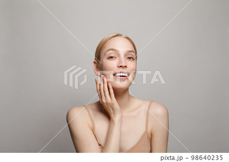 Closeup studio portrait of happy attractive woman Closeup studio portrait of happy attractive woman 98640235