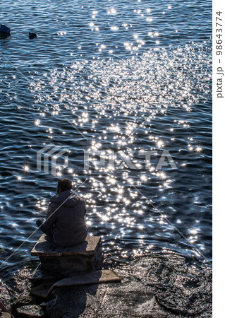 Man sitting and contemplating on beach.  Concept of freedom relaxation. 98643774
