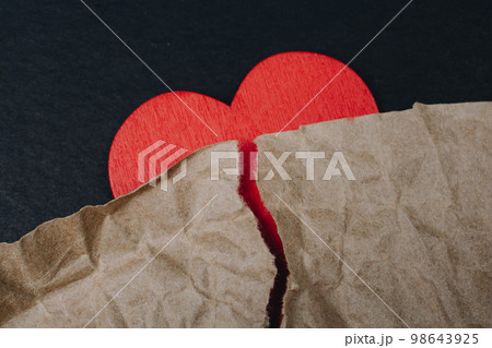 Torn wrinkled paper on heart.  Valentine concept 98643925